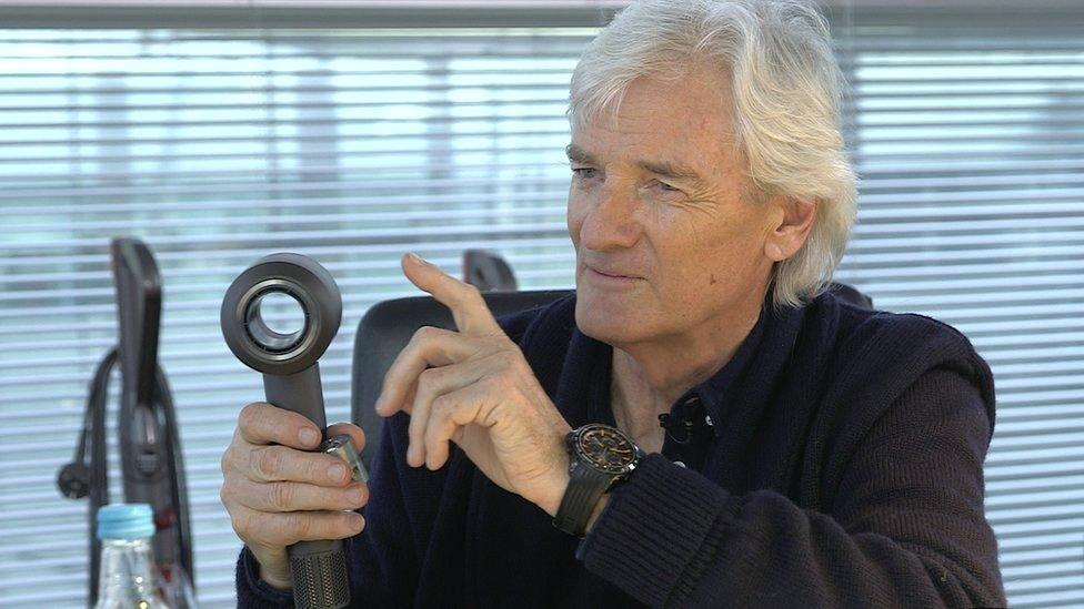 Sir James Dyson holds his new hairdryer