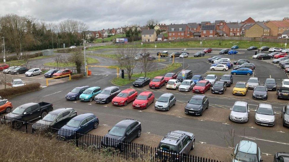 Car park showing most spaces full, with a separate car park to one side