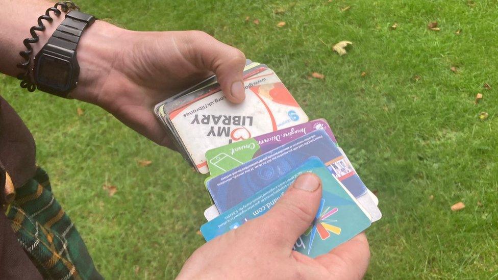 Adam Fergus holding library cards