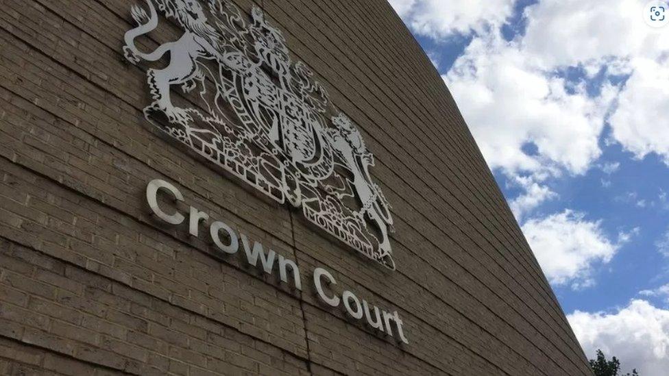 Concrete wall of crown court with coat of arms