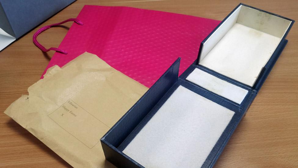 The pink gift bag, envelope and box that the notebooks were returned in