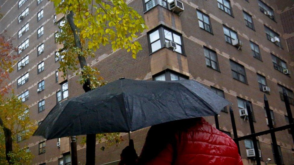 A person walks in front of the block of flats where Mr Elkinn was arrested