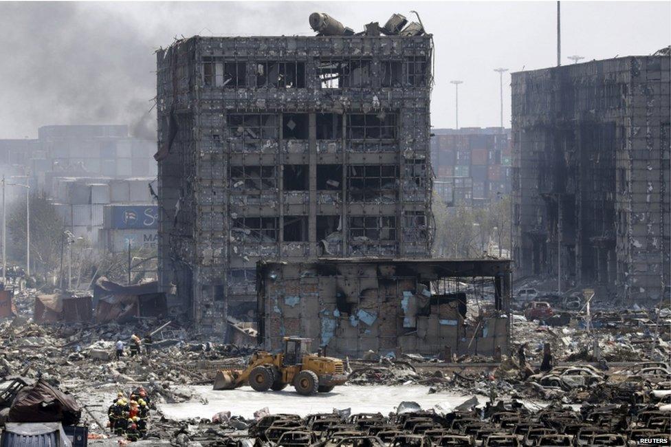 Damaged buildings and cars are seen near the site of the explosions at the Binhai new district, Tianjin, 13 August 2015