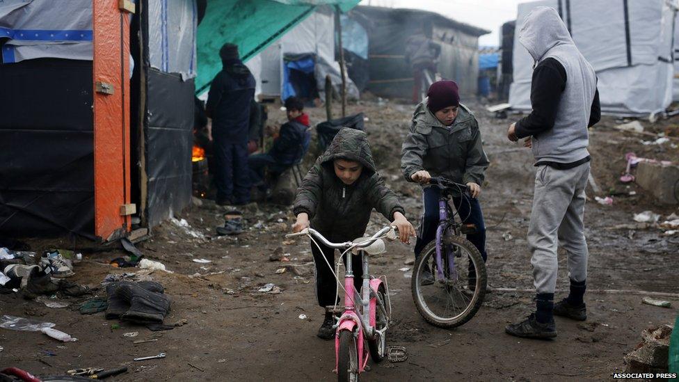 Children cycling in the Calais camp