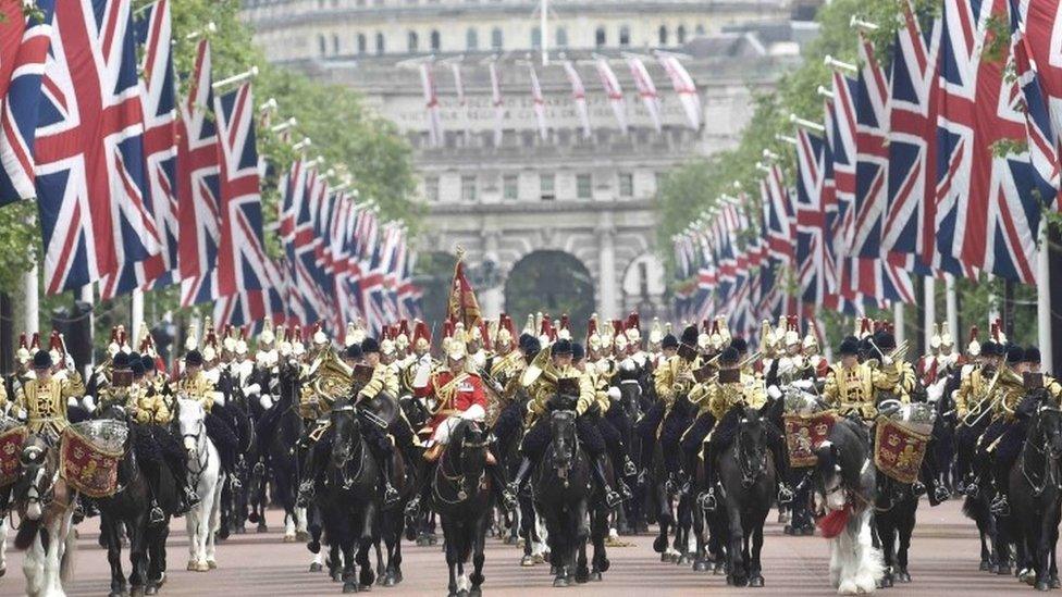 Guardsmen arrive back at Buckingham Palace from Horse Guards Parade after the annual Trooping the Colour ceremony in central London