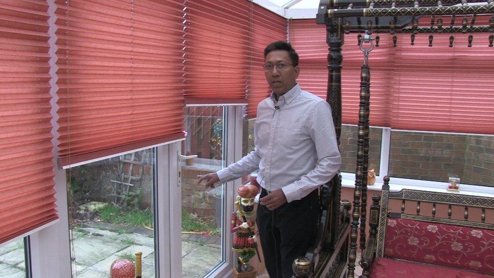 Sanjay Taunk, pointing to the door through which burglars entered his home and stole all his wife's gold jewellery.