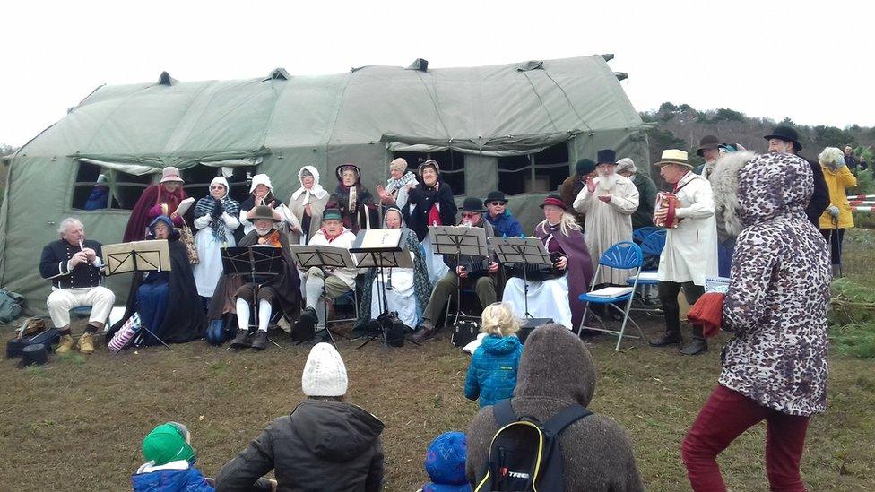 People singing carols at the pull a pine event