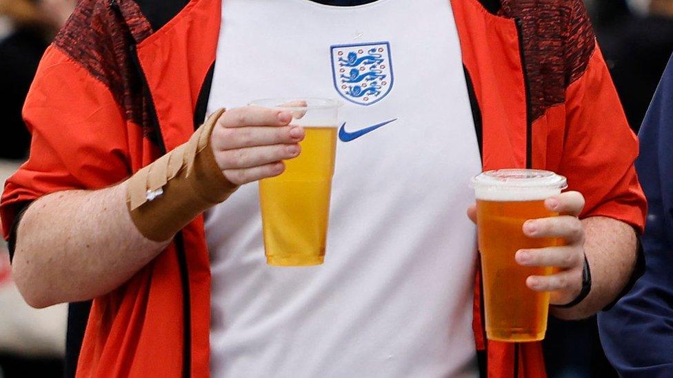 Football fan with two pints