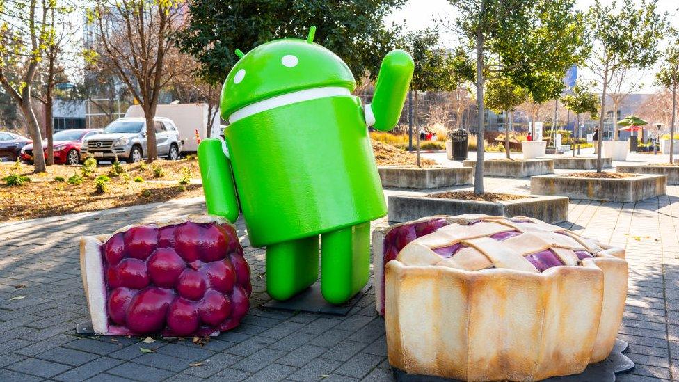 A sculpture of the Android logo with slices of pie sculptures