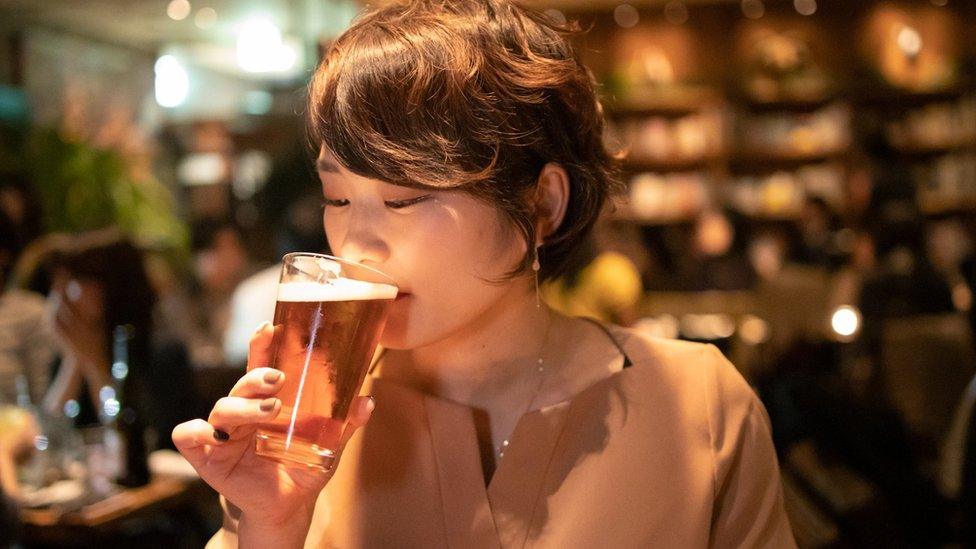 Young woman drinking beer