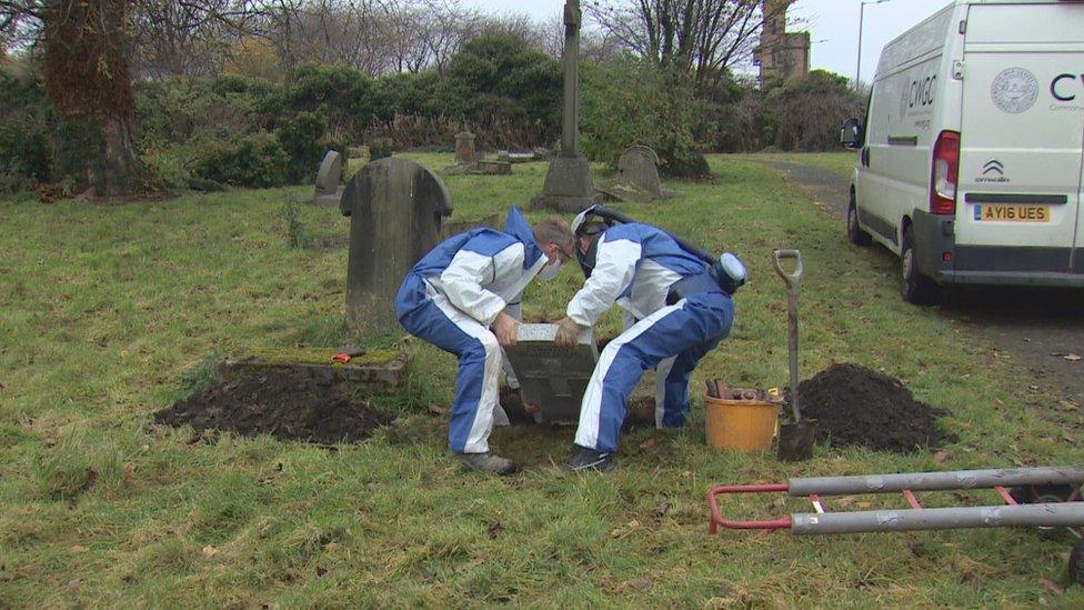 Gravestone being put in place