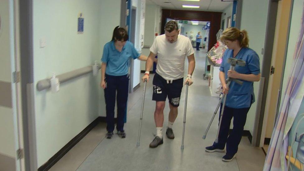 David McCallion walking on crutches after operation