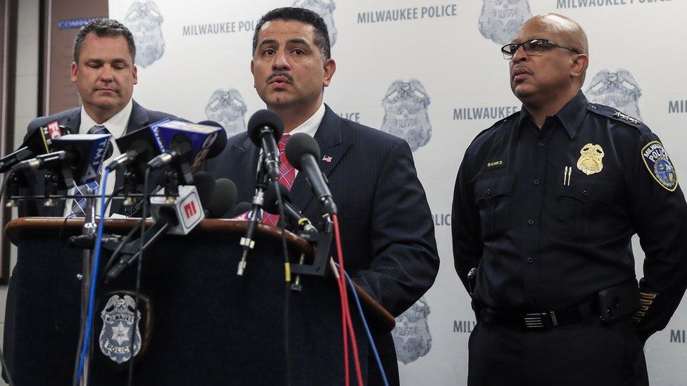 Milwaukee police chief Alfonso Morales, centre, making a statement to the press