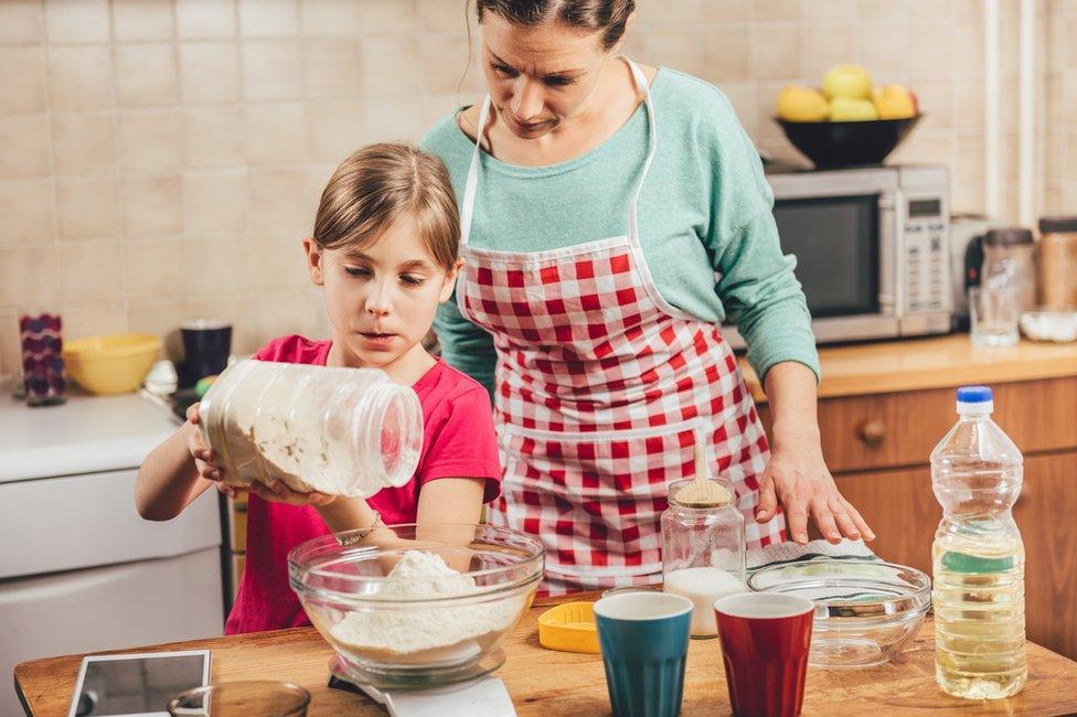 Woman and child baking