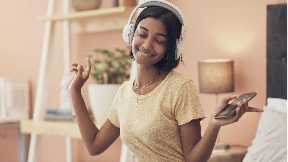 Woman dancing with headphones