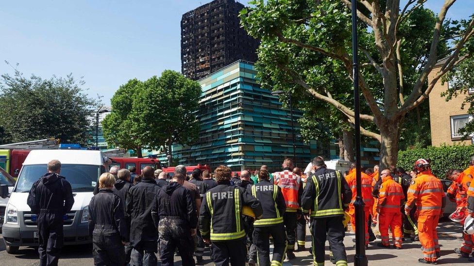 Firefighters at Grenfeell Tower after a minute's silence on Monday