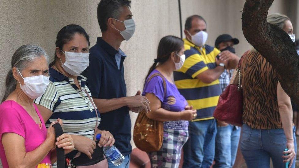 Residents line up to receive the Coronavac vaccine against COVID-19, in Serrana