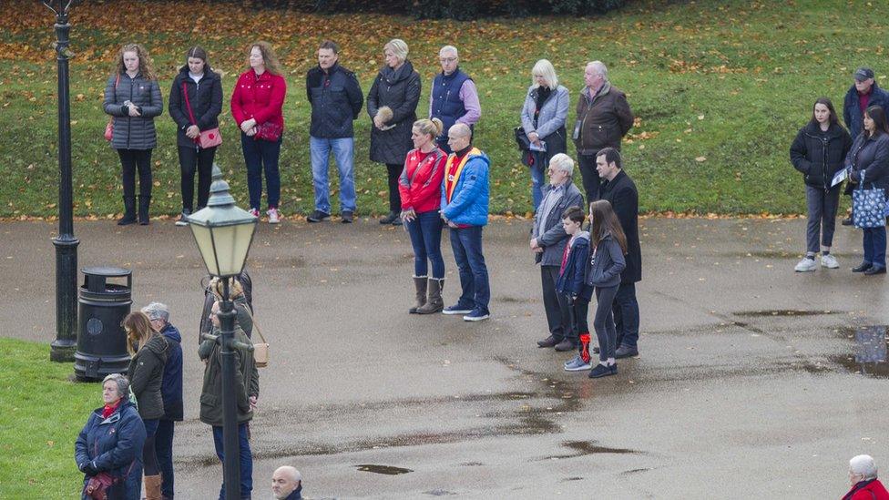 People stopping their business to observe a silence.