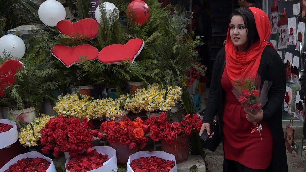 Woman in Kabul carrying roses