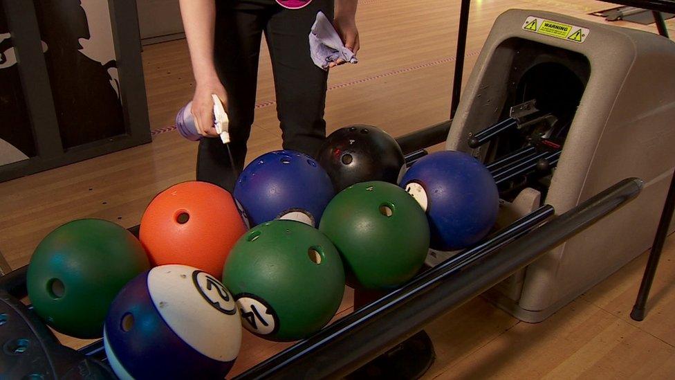 Staff clean bowling balls