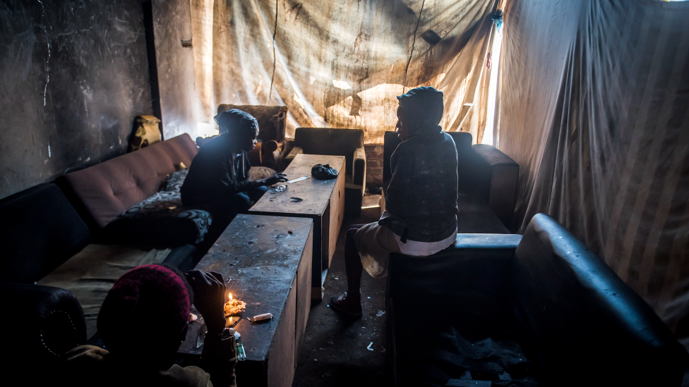 Residents as seen sitting in a room of the derelict San Jose building in Johannesburg, South Africa