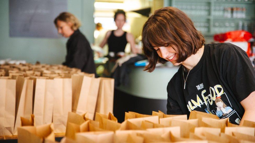 A person packing food into bags