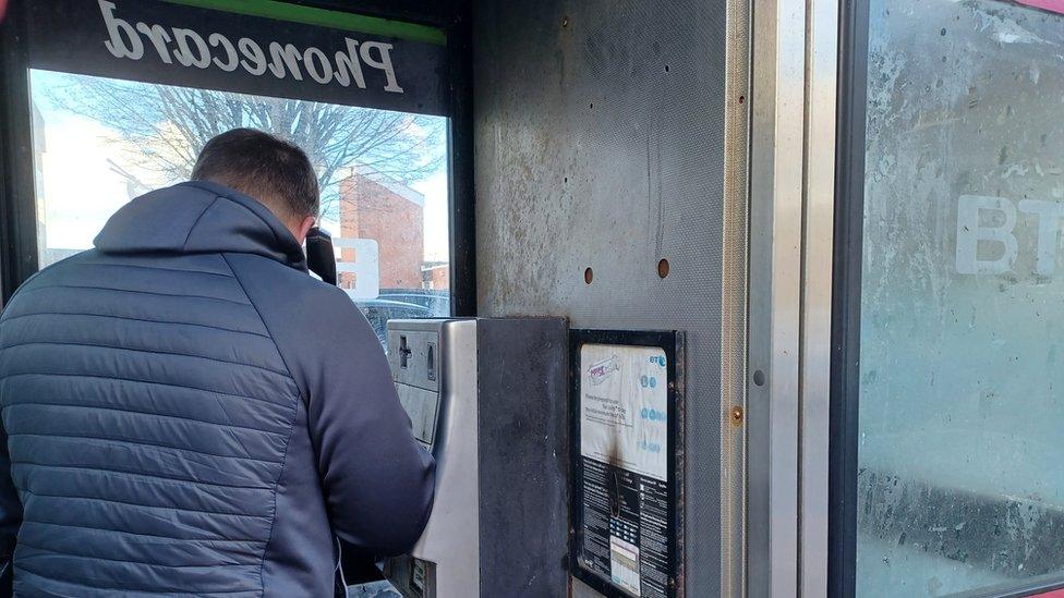 "Matthew" making a phone call from a phone box