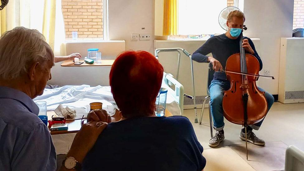 Cellist Chris Allen playing for patients