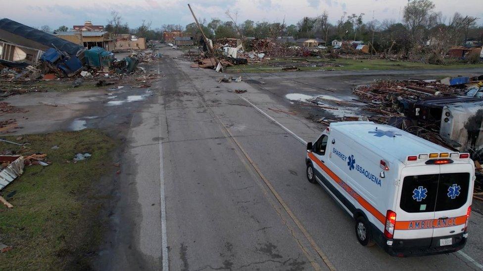 An ambulance arrives at Rolling Fork, Mississippi, which was devastated by a tornado, 25 March