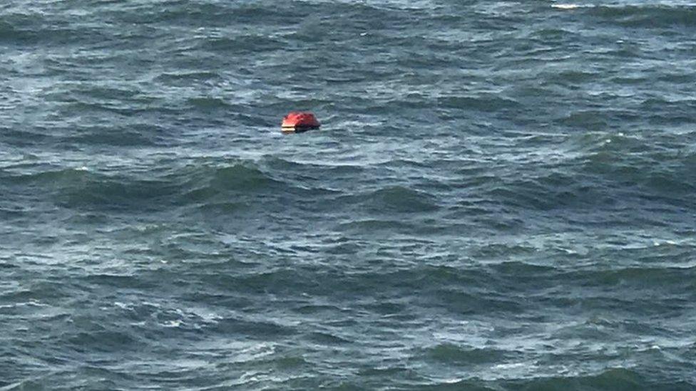 Three fishermen in a lifeboat who were rescued by crew from the Princess Cruise Lines" Pacific Princess as they drifted in the North Sea off the English coast.