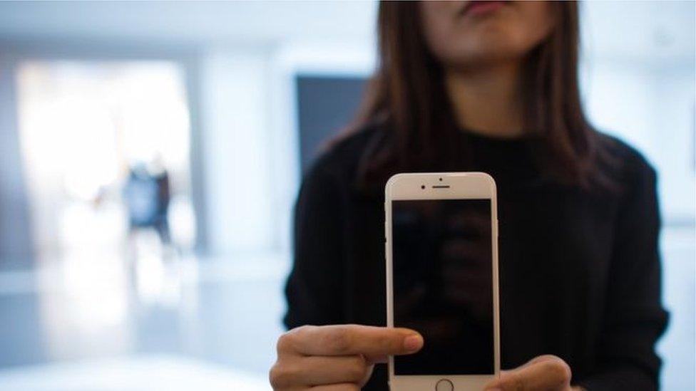 Woman holding iPhone