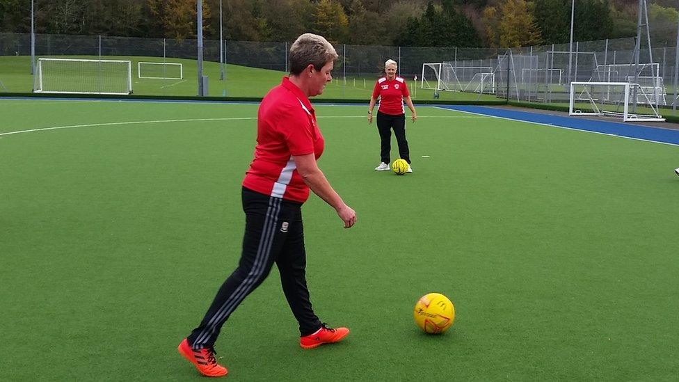 women playing football