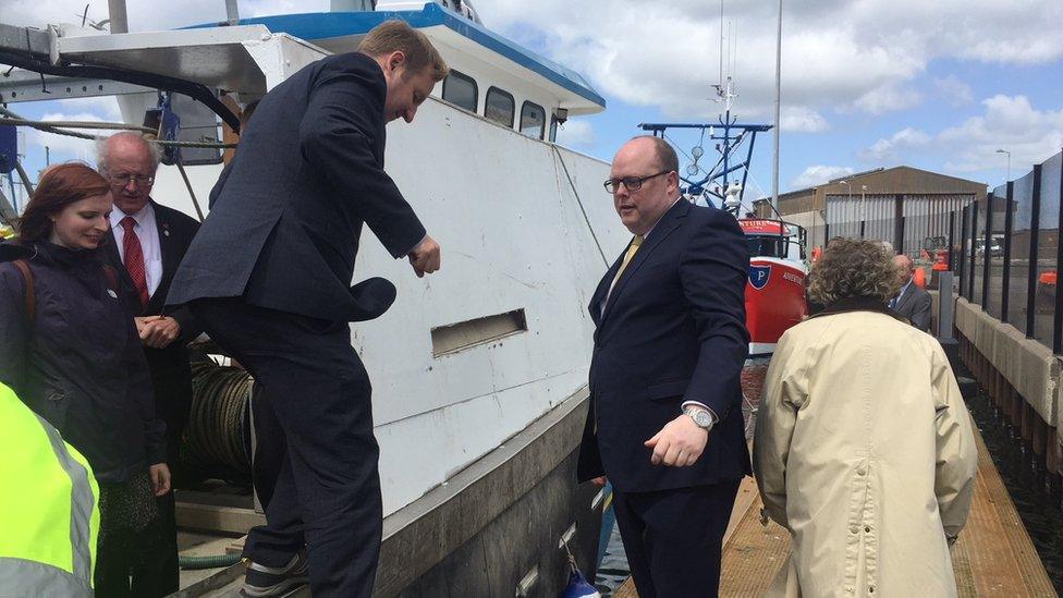 Fishermen's representative Harry Wick helps MPs off a Portavogie trawler