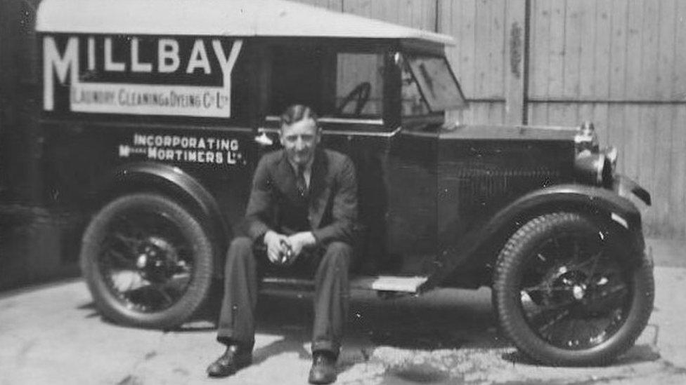 Leslie Tibbs sitting on his delivery van