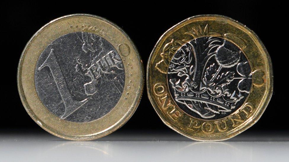 A one euro and one pound coin