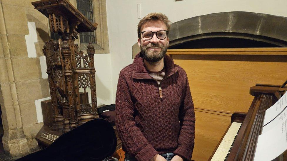 Sam Slatcher sitting at a piano