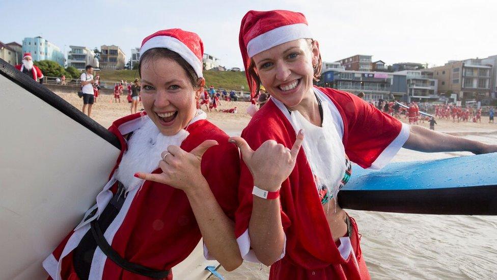 A pack of 320 surfing Santas embrace the Christmas spirit in Australia, breaking the Guinness World Record for the largest surf lesson.