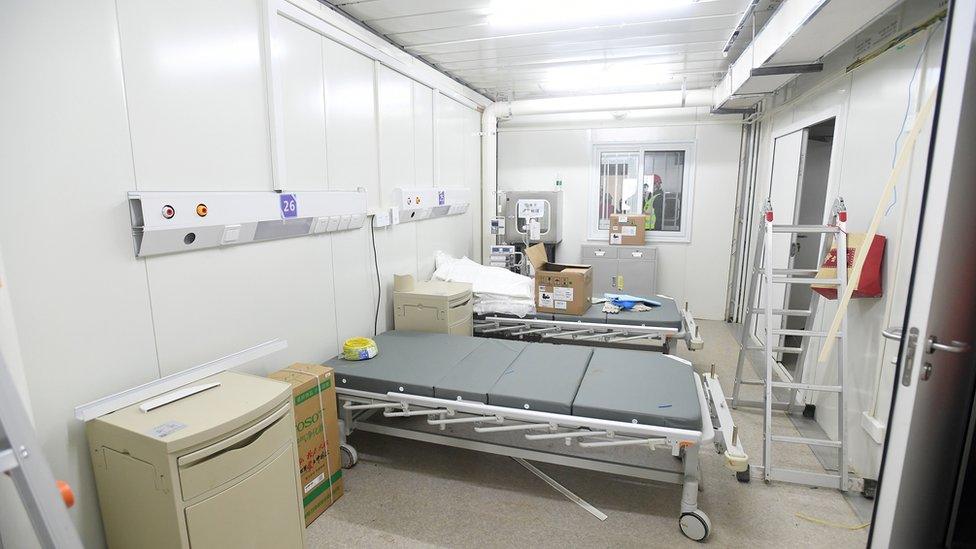 Hospital beds are set up inside the hospital