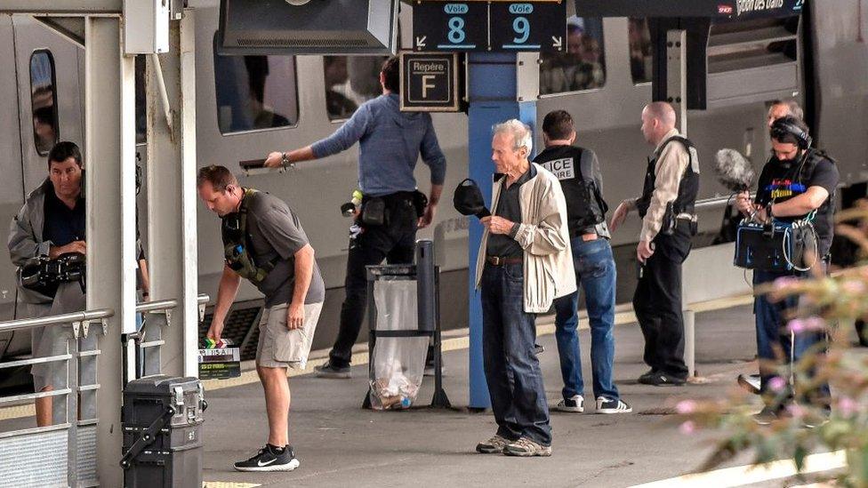 US film director Clint Eastwood (C) stands on a platform during the making of the film