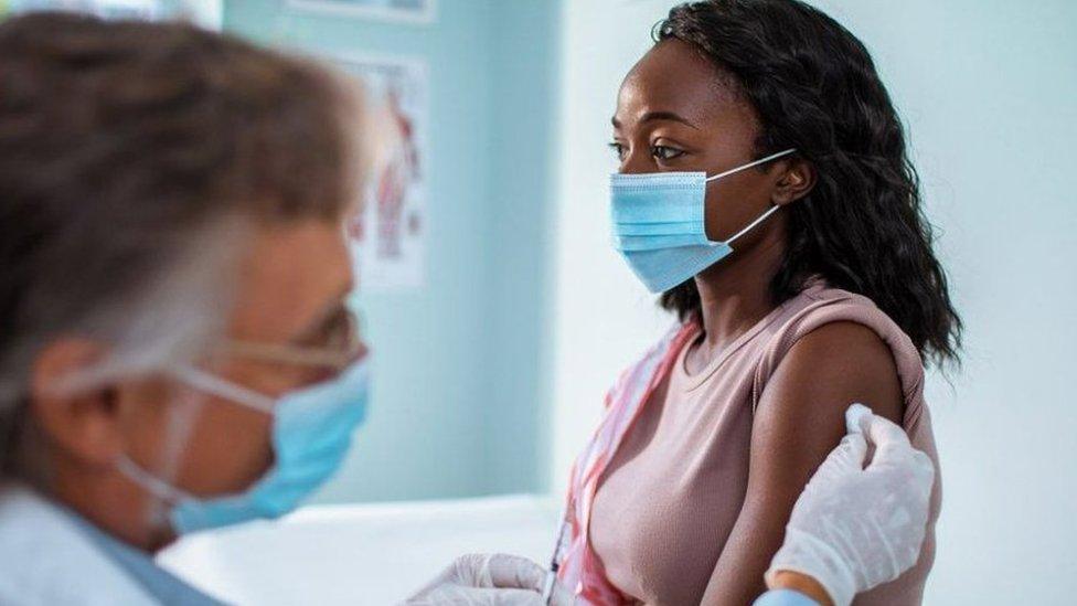 A woman receives a vaccination