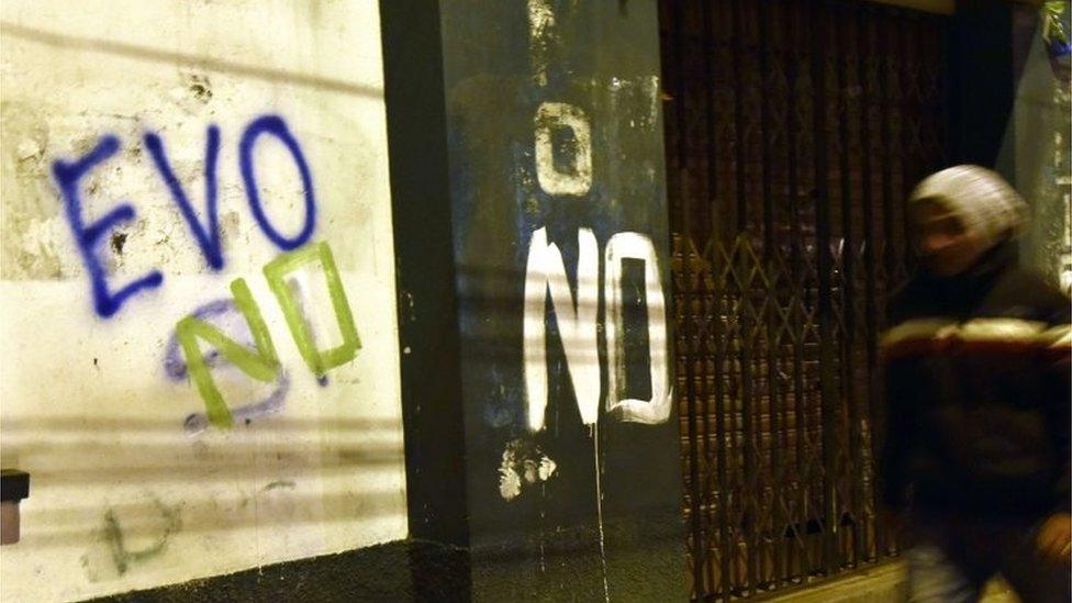 A man is seen walking next to a graffiti that reads "Evo no" after the referendum rejection in El Alto, Bolivia, on 21 February 2016.