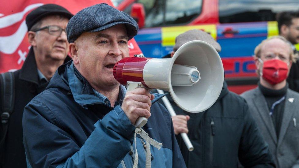 mick lynch protesting with a megaphone to a crowd