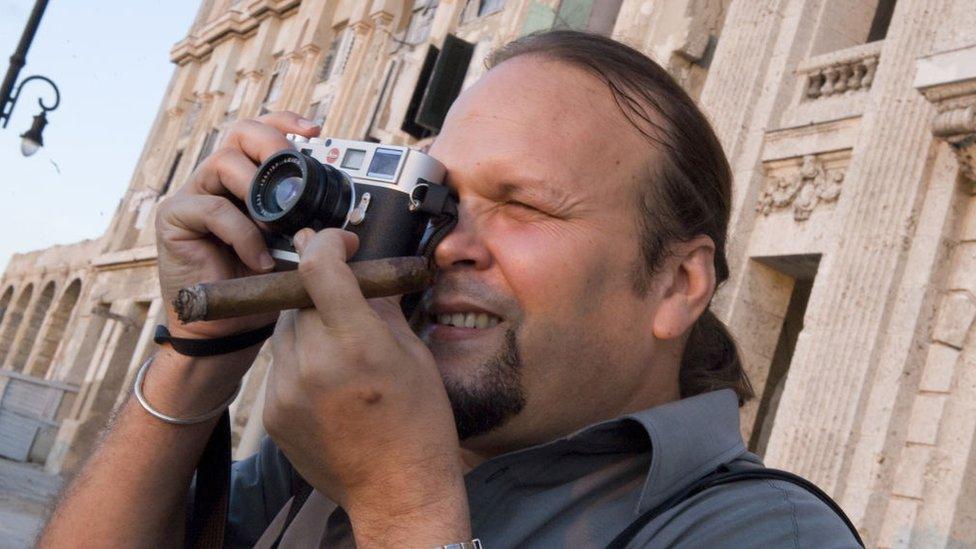 Camilo Guevara, son of late guerrilla leader Ernesto Che Guevara, takes pictures with his new M8 Leica-Che's 80 Anniversary edition, outside the Spanish American Centre in Havana, on June 03, 2008.