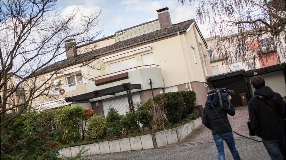 A camera man films a residential building in Sulzbach, Germany, 9 December 2015