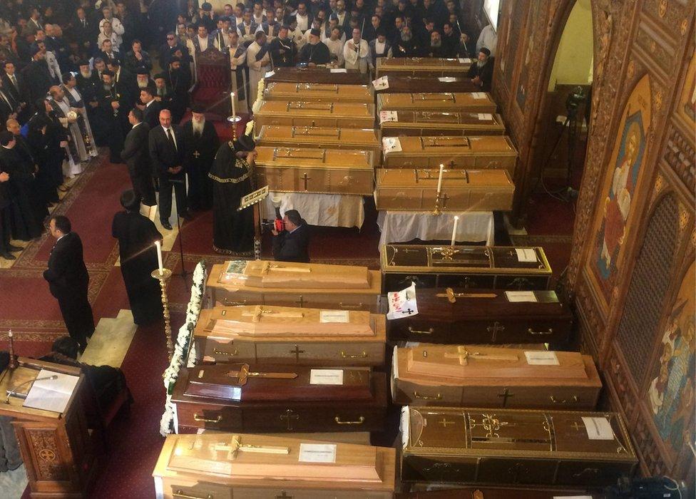 Pope Tawadros II praying over victims' coffins