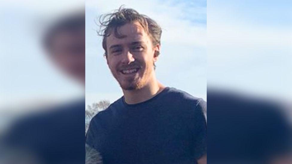 Picture of Sid Sefton he has brown hair and beard and is wearing a blue T-shirt