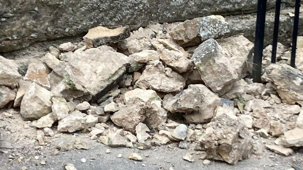 A pile of rubble where the wall has been damaged