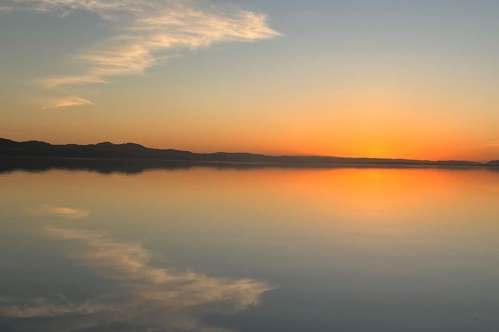 Sunset of orange glow reflected in the River Tay.