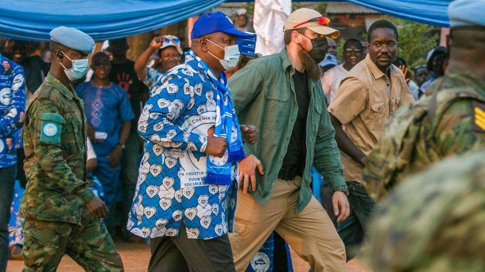 President Faustin-Archange Touadéra arrives at a stadium with a white bodyguard ahead of the presidential elections in Bangui, in December 2020.