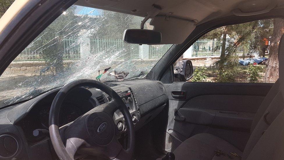 A damaged car outside the base